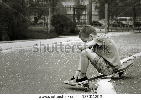 stock-photo-black-and-white-portrait-of-sad-lonely-child-who-sitting-on-skateboard-in-park-137011292